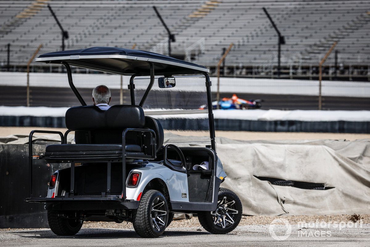 Roger Penske watches practice from turn 4