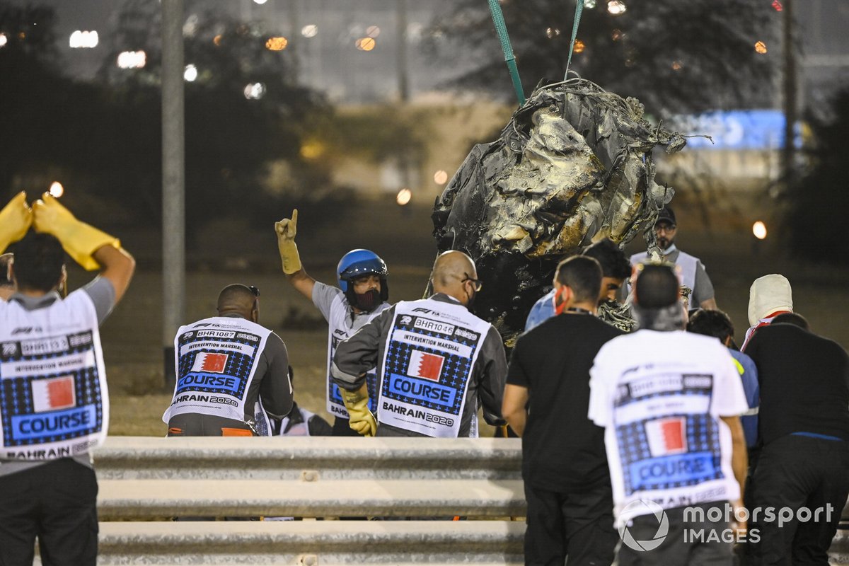 Marshals remove the wreckage after a huge crash for Romain Grosjean, Haas VF-20, on the opening lap