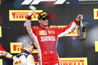 Max Verstappen, Red Bull Racing, 2nd position, and Kimi Raikkonen, Ferrari, 1st position, celebrate with Champagne on the podium