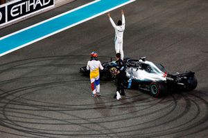 Lewis Hamilton, Mercedes AMG F1 W09 EQ Power+, celebrates on his car as he is congratulated by Fernando Alonso, McLaren, on the grid