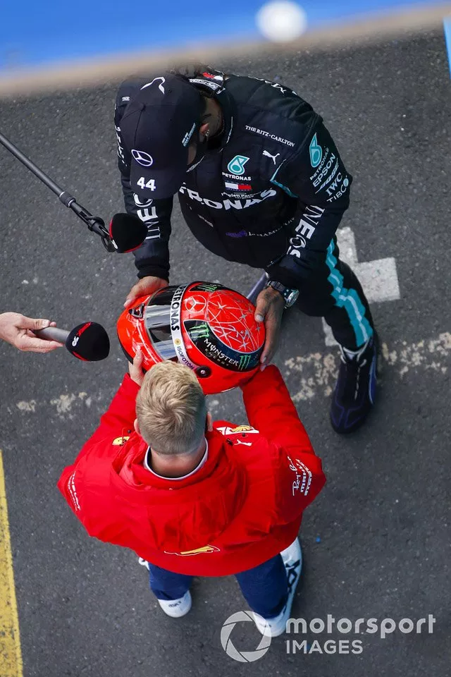 Mick Schumacher, Alfa Romeo Racing, presents race winner Lewis Hamilton, Mercedes-AMG F1, with the Mercedes helmet of his father, Michael Schumacher, from 2012