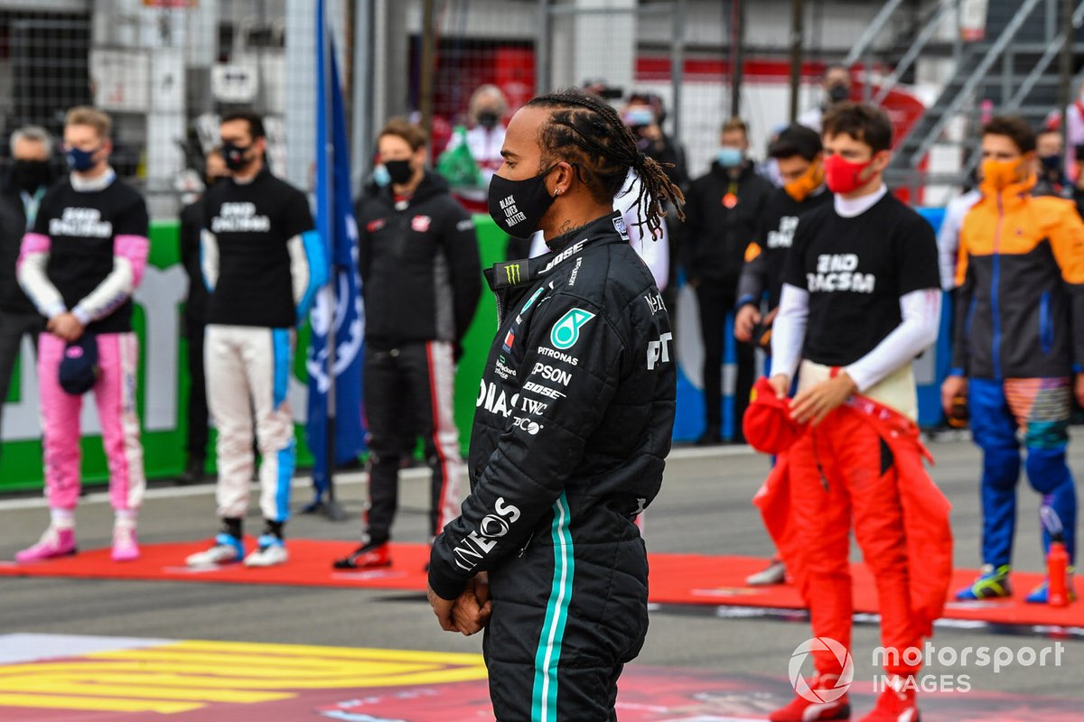 Lewis Hamilton, Mercedes-AMG F1, and the other drivers stand on the grid