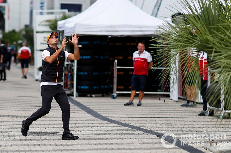Carlos Sainz Jr., McLaren, catches a rugby ball