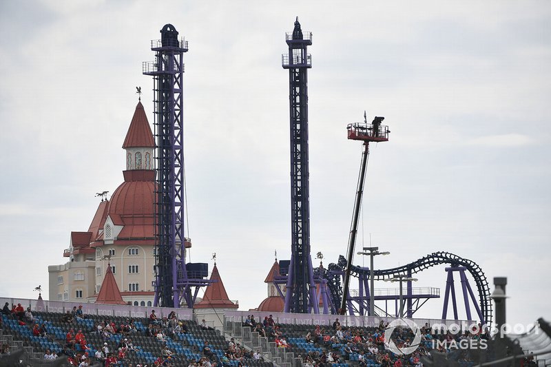 Fairground rides behind a grandstand