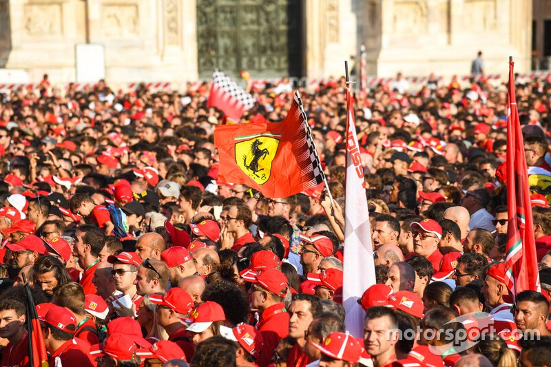 A Ferrari flag waves amidst the crowd