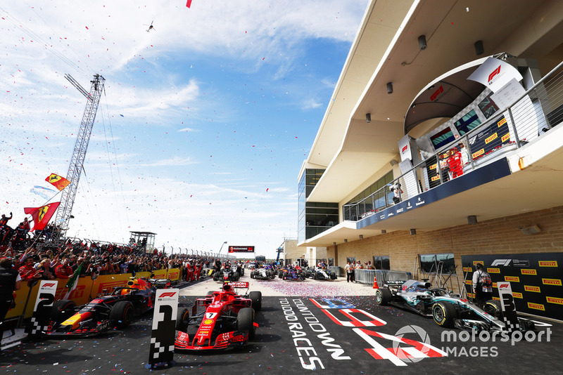 Kimi Raikkonen, Ferrari SF71H, celebrates on the podium with Max Verstappen, Red Bull Racing, and Lewis Hamilton, Mercedes AMG F1 W09 EQ Power+, after winning the race.