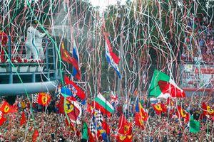 Valtteri Bottas, Mercedes AMG F1, third position, and Lewis Hamilton, Mercedes AMG F1, first position, spray Champagne from the podium as streamers fall