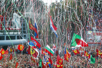 Valtteri Bottas, Mercedes AMG F1, third position, and Lewis Hamilton, Mercedes AMG F1, first position, spray Champagne from the podium as streamers fall