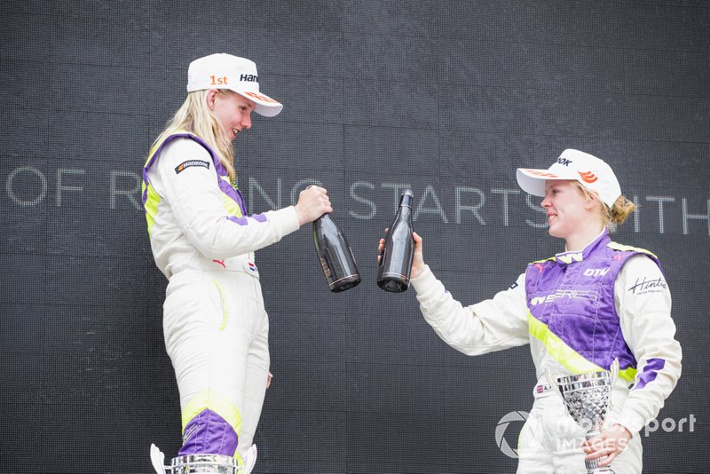 Beitske Visser celebrates on the podium after winning the race with Alice Powell