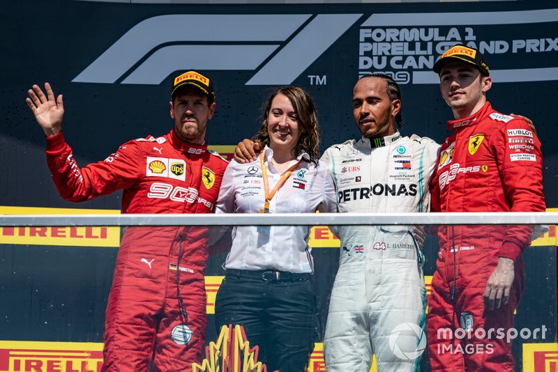 Sebastian Vettel, Ferrari, 2nd position, the Mercedes Constructors trophy delegate, Lewis Hamilton, Mercedes AMG F1, 1st position, and Charles Leclerc, Ferrari, 3rd position, on the podium