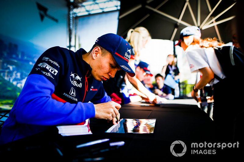 Alexander Albon, Toro Rosso signs autographs for fans