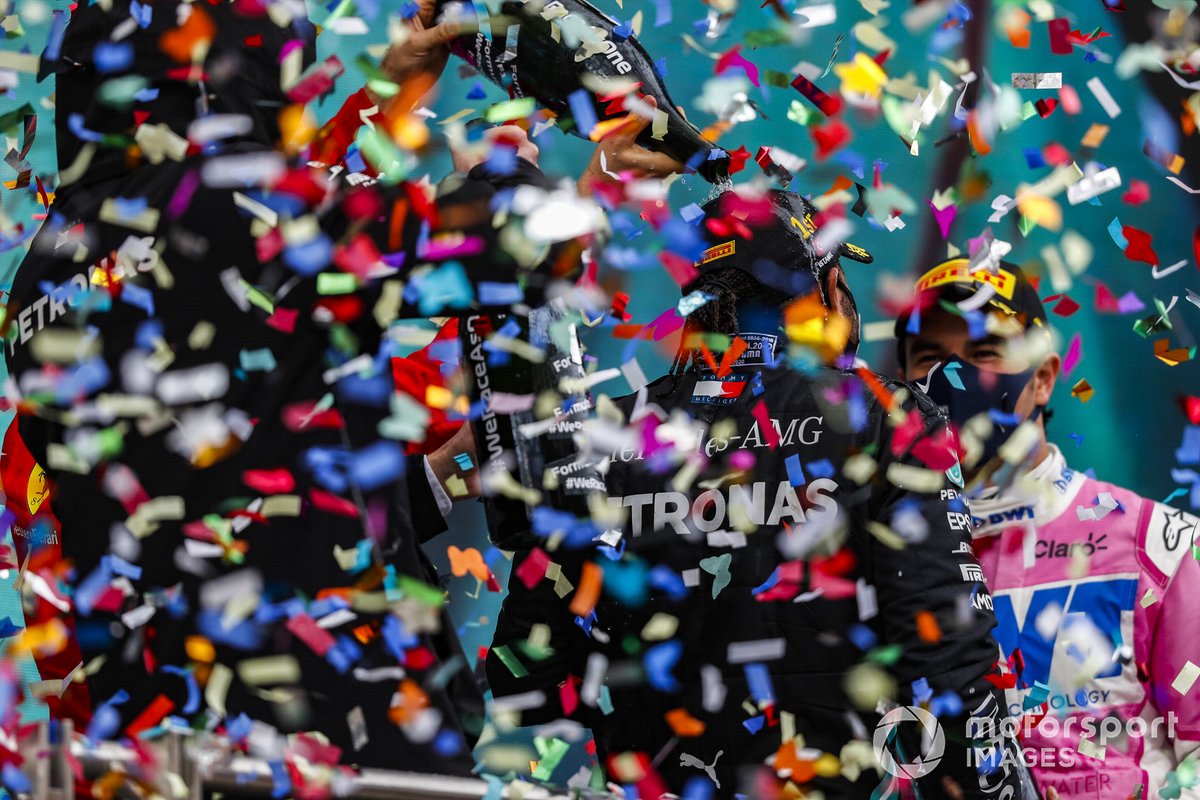 Sebastian Vettel, Ferrari, 3rd position, and Sergio Perez, Racing Point, 2nd position, pour Champagne over Lewis Hamilton, Mercedes-AMG F1, 1st position, on the podium