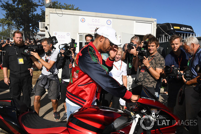 Lewis Hamilton, Mercedes AMG F1 arrives at the track on his motorbike