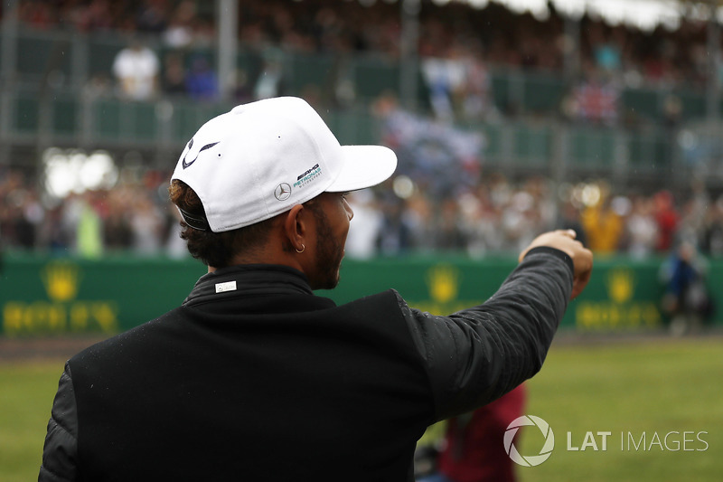 Lewis Hamilton, Mercedes AMG F1, points to fans in a grandstand