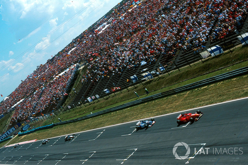 Michael Schumacher, Ferrari F310B leads Damon Hill, Arrows