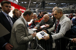 Nigel Mansell signs autographs for fans