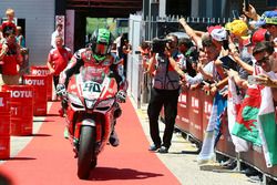 Third place Eugene Laverty,  Milwaukee Aprilia rides into parc ferme