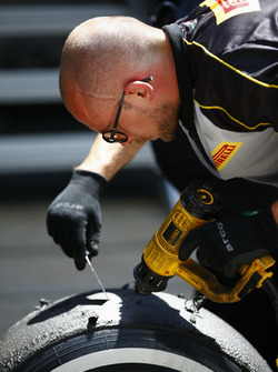 A Pirelli engineer works on some tyres