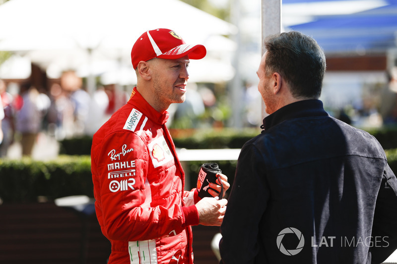 Sebastian Vettel, Ferrari, talks with Christian Horner, Team Principal, Red Bull Racing