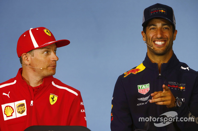 Kimi Raikkonen, Ferrari, and Daniel Ricciardo, Red Bull Racing, share a joke in the Thursday press conference