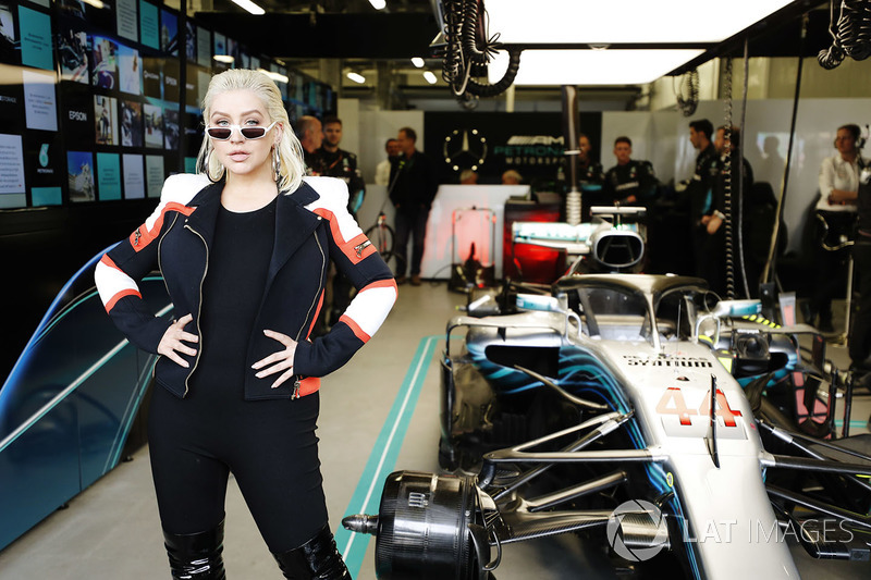 Christina Aguilera poses for a photo with the car of Lewis Hamilton, Mercedes AMG F1 W09