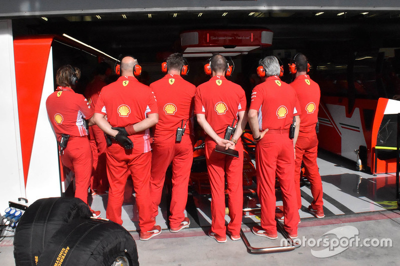 Ferrari mechanics cover the garage