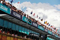 Fans watch action from above the pit lane