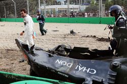 Fernando Alonso, looks at his McLaren MP4-31 after his race stopping crash