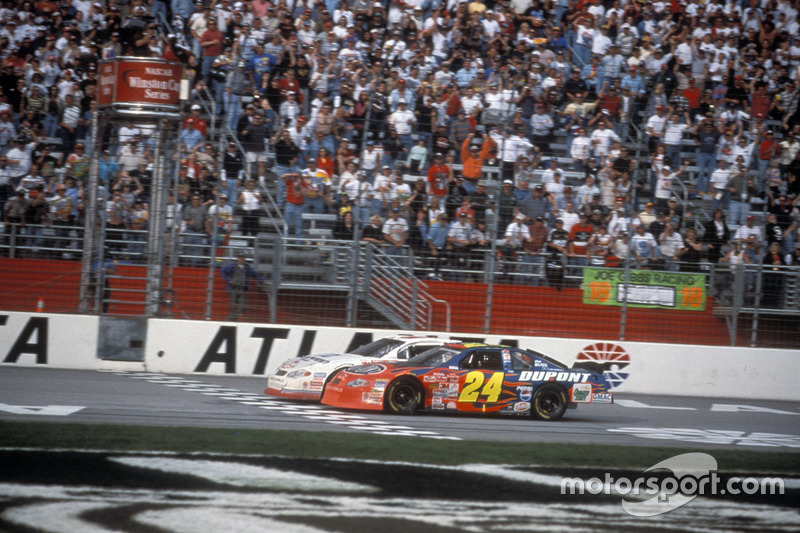 Kevin Harvick takes the checkred flag ahead of Jeff Gordon