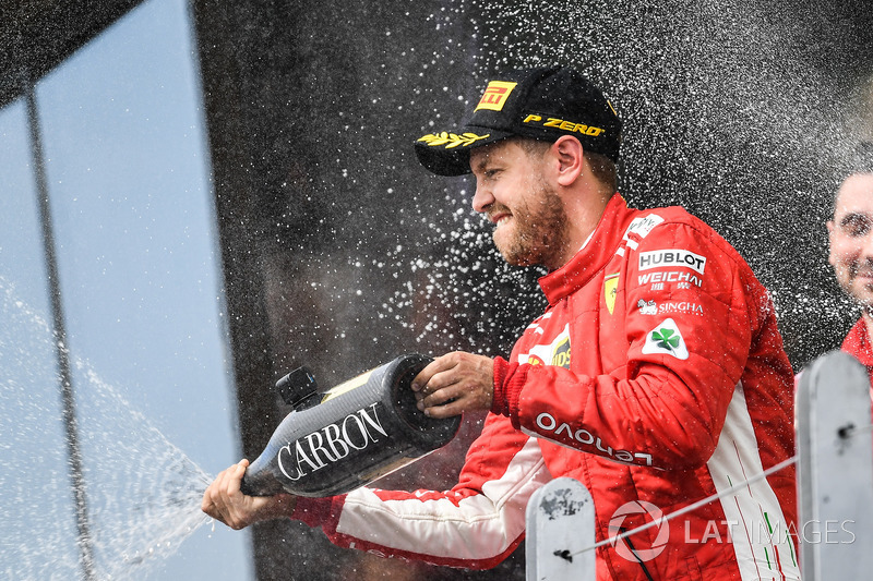 Race winner Sebastian Vettel, Ferrari celebrates on the podium with the champagne