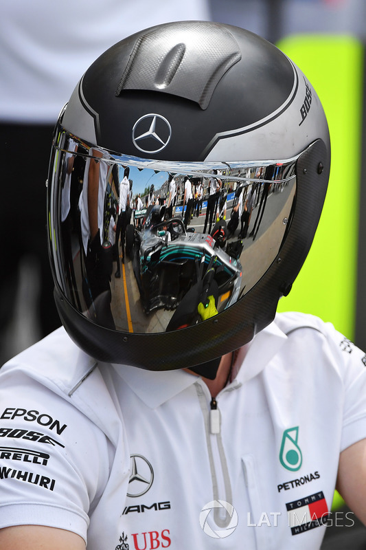 McLaren mechanic with reflection in helmet