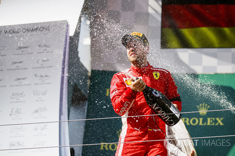 Sebastian Vettel, Ferrari celebrates by spraying champagne on the podium