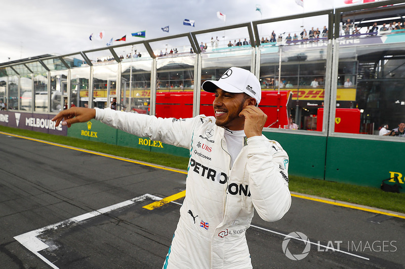 Lewis Hamilton, Mercedes AMG F1, celebrates taking pole position alongside on the pit straight