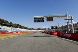 Green lights on the starting light gantry above the pit straight