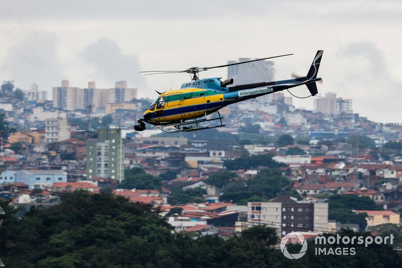 An HelibrÃ¡s AS-350B3 Esquilo (license built Eurocopter AS-350 Squirrel) camera helicopter in the same colours as the helmet of Ayrton Senna