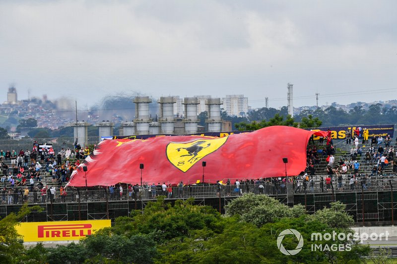 The crowd unveils a huge Ferrari flag
