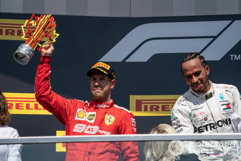 Sebastian Vettel, Ferrari, 2nd position, lifts his trophy on the podium