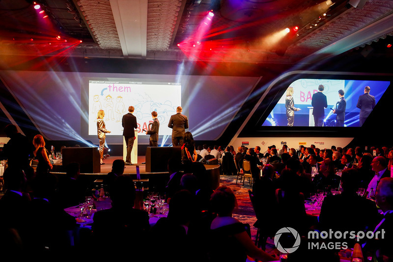 Williams F1 Driver George Russell, and McLaren F1 driver Lando Norris on stage with hosts Nicki Shields and David Croft