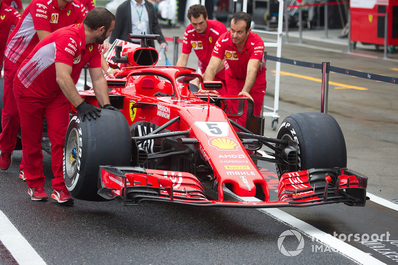 Ferrari mechanics pushing Ferrari SF71H with new Ferrari livery 