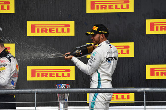 Lewis Hamilton, Mercedes AMG F1 celebrates with the champagne on the podium with the trophy