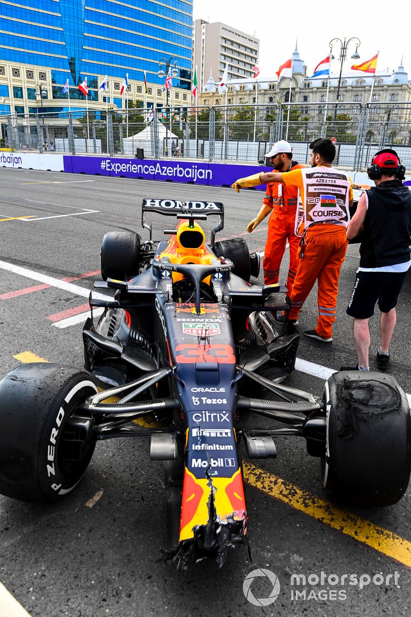 Marshals with the dmaaged car of Max Verstappen, Red Bull Racing RB16B