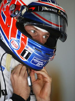 Jenson Button, McLaren MP4-31 adjusts his crash helmet