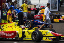 GP2 cars leave the paddock