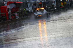 The FIA Safety Car heads down the pit lane as rain delays qualifying