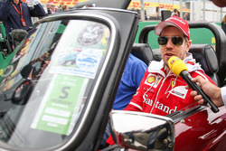 Sebastian Vettel, Ferrari talks to the media on the drivers parade