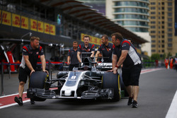 Haas F1 Team team members push the Romain Grosjean Haas F1 Team VF-17 along the pit lane