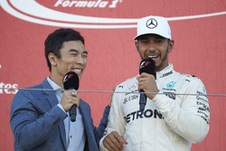 Takuma Sato interviews Race winner Lewis Hamilton, Mercedes AMG F1, on the podium