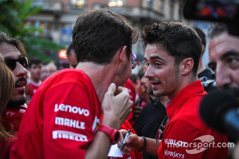 Charles Leclerc, Ferrari talks to a fan as he signs an autograph