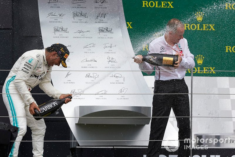 Lewis Hamilton, Mercedes AMG F1, 1st position, sprays Champagne at his team mate on the podium