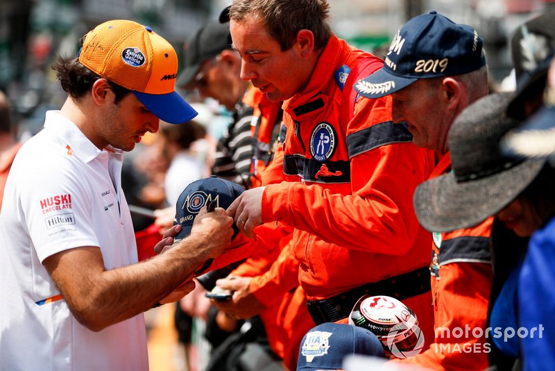 Carlos Sainz Jr., McLaren signs a autograph for a marshal